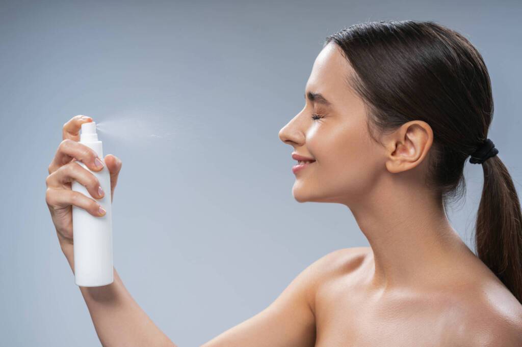 Smiling female with a ponytail doing a beauty procedure